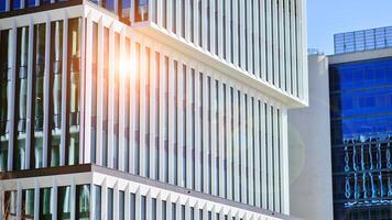 Modern office building in the city with windows and steel and aluminum panels wall. Contemporary commercial architecture, vertical converging geometric lines. photo