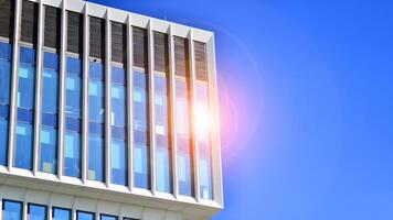 Modern office building in the city with windows and steel and aluminum panels wall. Contemporary commercial architecture, vertical converging geometric lines. photo