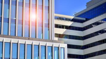 Modern office building in the city with windows and steel and aluminum panels wall. Contemporary commercial architecture, vertical converging geometric lines. photo