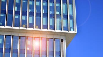 Modern office building in the city with windows and steel and aluminum panels wall. Contemporary commercial architecture, vertical converging geometric lines. photo