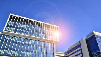 Modern office building in the city with windows and steel and aluminum panels wall. Contemporary commercial architecture, vertical converging geometric lines. photo