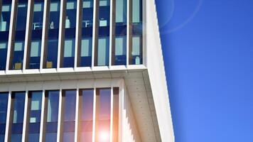 Modern office building in the city with windows and steel and aluminum panels wall. Contemporary commercial architecture, vertical converging geometric lines. photo