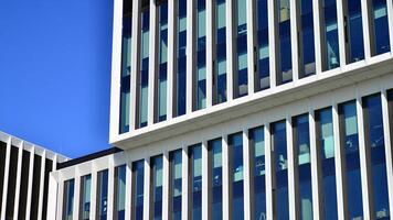 moderno oficina edificio en el ciudad con ventanas y acero y aluminio paneles pared. contemporáneo comercial arquitectura, vertical convergente geométrico líneas. foto