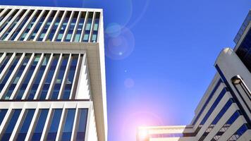 Modern office building in the city with windows and steel and aluminum panels wall. Contemporary commercial architecture, vertical converging geometric lines. photo