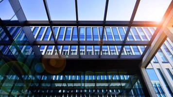 Modern office building in the city with windows and steel and aluminum panels wall. Contemporary commercial architecture, vertical converging geometric lines. photo