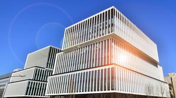 Modern office building in the city with windows and steel and aluminum panels wall. Contemporary commercial architecture, vertical converging geometric lines. photo