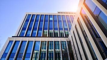 Modern office building in the city with windows and steel and aluminum panels wall. Contemporary commercial architecture, vertical converging geometric lines. photo