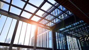 Modern office building in the city with windows and steel and aluminum panels wall. Contemporary commercial architecture, vertical converging geometric lines. photo