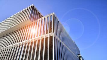 Modern office building in the city with windows and steel and aluminum panels wall. Contemporary commercial architecture, vertical converging geometric lines. photo