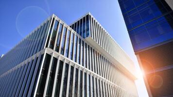 Modern office building in the city with windows and steel and aluminum panels wall. Contemporary commercial architecture, vertical converging geometric lines. photo