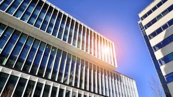 Modern office building in the city with windows and steel and aluminum panels wall. Contemporary commercial architecture, vertical converging geometric lines. photo