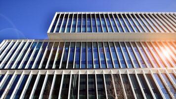 Modern office building in the city with windows and steel and aluminum panels wall. Contemporary commercial architecture, vertical converging geometric lines. photo