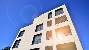 View of a white modern apartment building. Perfect symmetry with blue sky. Geometric architecture detail modern concrete structure building. Abstract concrete architecture. photo