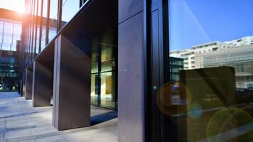 Entrance of the modern business city office building. Modern urban architecture. The front door of a office block, reflecting buildings in the glass. photo