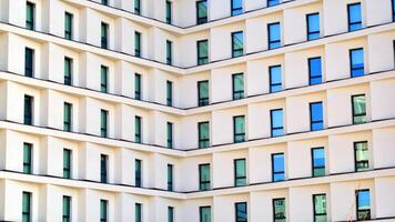 View of a white modern apartment building. Perfect symmetry with blue sky. Geometric architecture detail modern concrete structure building. Abstract concrete architecture. photo
