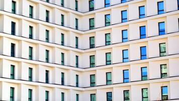 View of a white modern apartment building. Perfect symmetry with blue sky. Geometric architecture detail modern concrete structure building. Abstract concrete architecture. photo