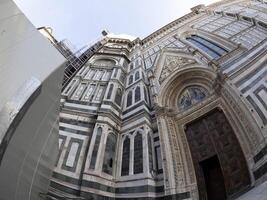 fisheye unusual view Cathedral Santa Maria dei Fiori, Brunelleschi Dome and Giotto Tower in Florence Italy photo