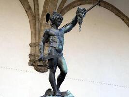 Detail of Perseus holding head of Medusa, bronze statue in Loggia de Lanzi, Piazza della Signoria, Florence, Italy. Isolated on white photo