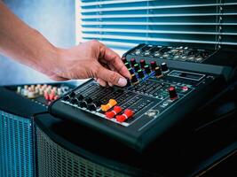 Sound engineer hands adjusting control sound mixer in recording, broadcasting studio,Sound mixer. Professional audio mixing console, buttons, faders and sliders. sound check. photo