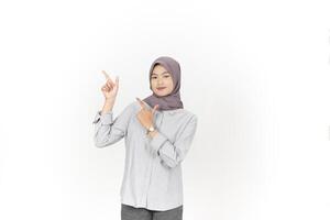 Young Asian woman wearing hijab Pointing side copy space isolated on white background photo