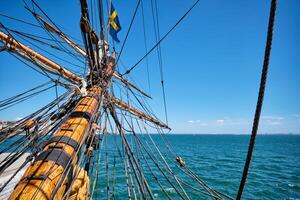 Bowspirit of old wooden sail ship with lots of rope gear photo