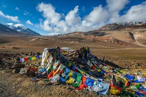 Buddhist prayer flags lungta on Baralacha La pass in Himalayas photo