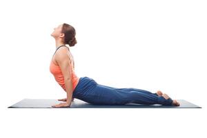 Sporty fit yogini woman practices yoga asana Urdhva mukha svanas photo