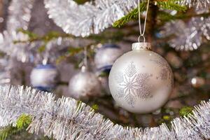 Decoration bauble on decorated Christmas tree photo
