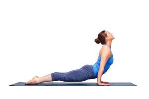 Sporty fit yogini woman practices yoga asana Urdhva mukha svanas photo