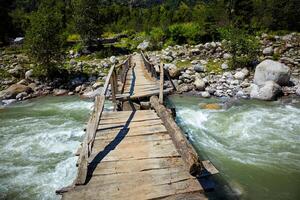 Bridge over river in Himalayas photo