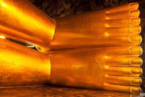 Reclining gold Buddha statue feet, Thailand photo