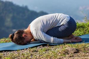 Sporty fit woman practices yoga asana Balasana photo