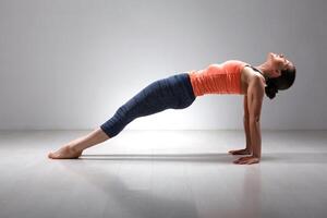 Sporty fit yogini woman practices Ashtanga Vinyasa photo