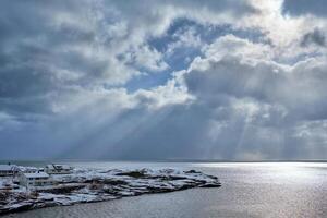 Norwegian sea in winter with sun rays photo