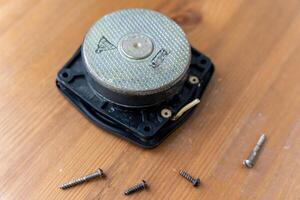 speaker disassembled into components, circuit board, and wires photo