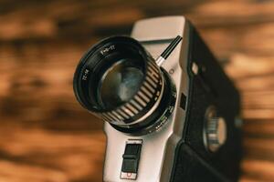 A close-up of a vintage movie camera shooting on 8 mm film from the 80s. photo