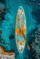 AI generated Multicolored SUP board on a blue sea background photo