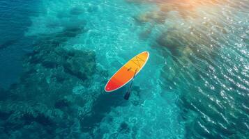 AI generated Multicolored SUP board on a blue sea background photo