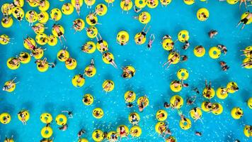 Top view of People relaxing in the pool on yellow inflatable circles photo