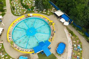 Top view of an outdoor place for people to relax where there is a swimming pool and a lot of sun beds photo