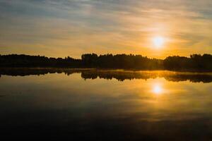 Top view of lake Drivyaty in the forest in the Braslav lakes National Park at sunset, the most beautiful places in the city of Belarus.An island in the lake.Belarus. photo