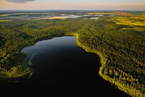 Top view of Bolta lake in the forest in the Braslav lakes National Park at dawn, the most beautiful places in Belarus.An island in the lake.Belarus. photo