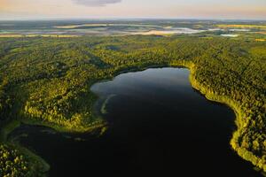 Top view of Bolta lake in the forest in the Braslav lakes National Park at dawn, the most beautiful places in Belarus.An island in the lake.Belarus. photo