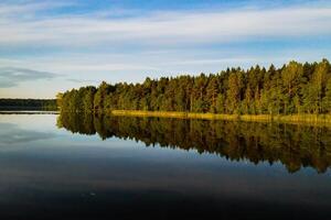 Top view of Bolta lake in the forest in the Braslav lakes National Park at dawn, the most beautiful places in Belarus.An island in the lake.Belarus. photo