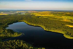 Top view of Bolta lake in the forest in the Braslav lakes National Park at dawn, the most beautiful places in Belarus.An island in the lake.Belarus. photo