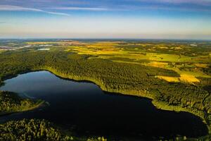 Top view of Bolta lake in the forest in the Braslav lakes National Park at dawn, the most beautiful places in Belarus.An island in the lake.Belarus. photo