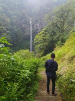 Malang, Indonesia, 22 October 2023 - View of people and Watu Ondo waterfall, Malang photo