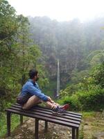 Malang, Indonesia, 22 October 2023 - View of people and Watu Ondo waterfall, Malang photo