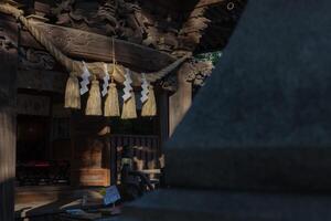 A sacred rope in front of the temple at Japanese Shrine photo