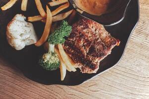 Tasty Grilled Meat with Fries and Vegetables photo